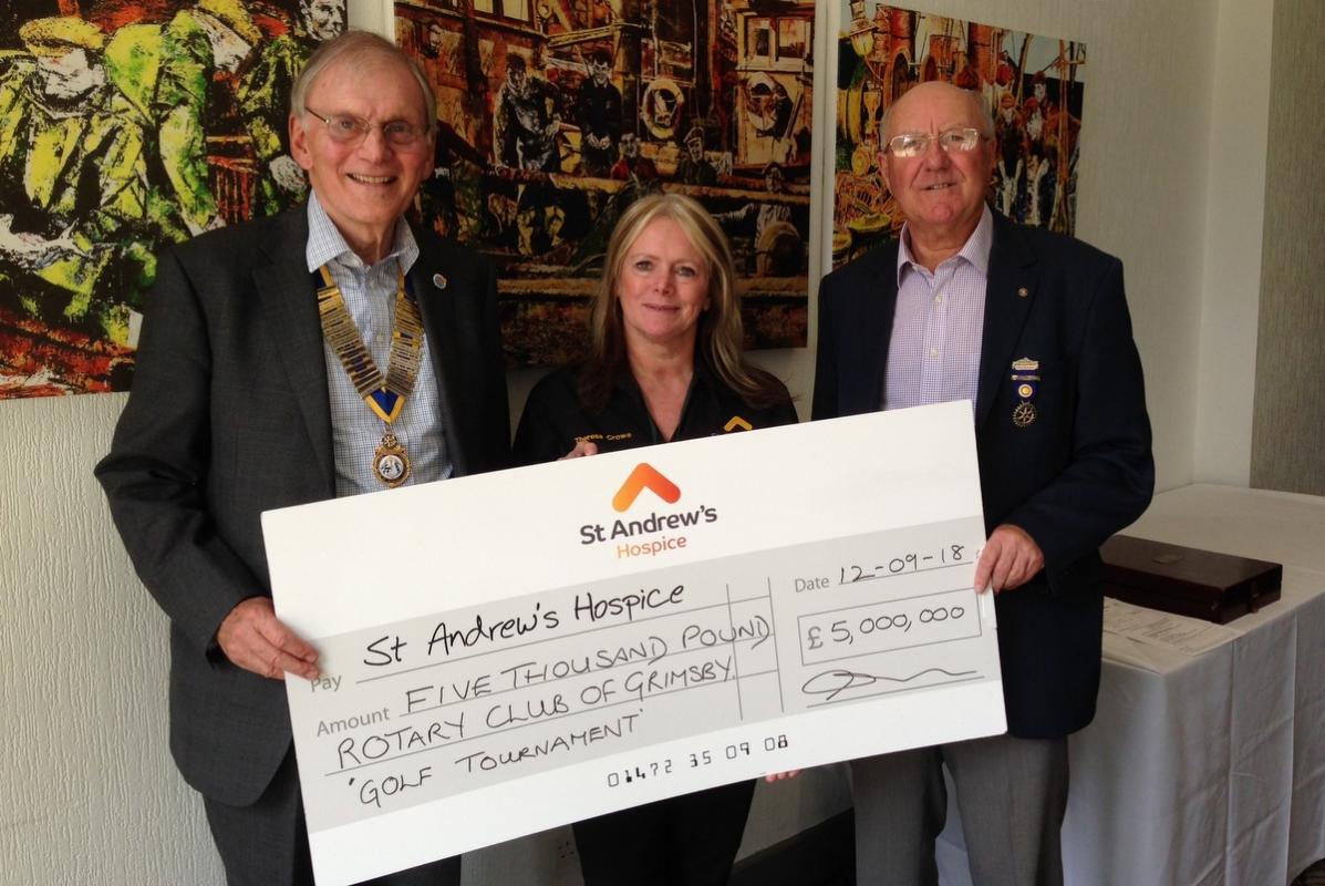 President Chris and Start Falconer present a cheque to Theresa 