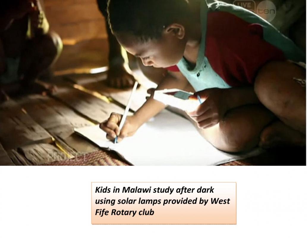 Children in Malawi study after dark using solar lights supplied by the Rotary Club of West Fife