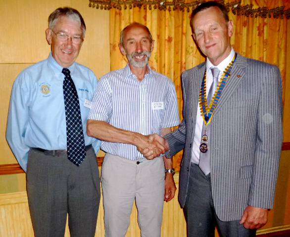 Hywel Watkin is welcomed into Rotary membership by President Dilwyn.  Looking on is Hywel's sponsor Rotarian Gwilym Williams (left)