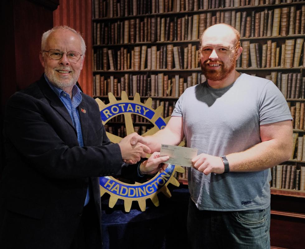 Mark Coull receives a cheque from Vice-President Malcolm Collins