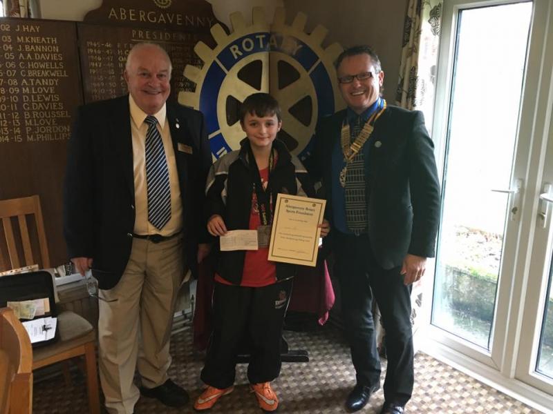 Dylan Ruck receiving his Rotary Sports Award from President Keith Davies in the presence of Rotarian Clive Howells