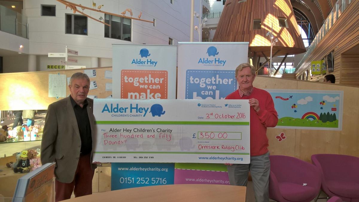 Past President Paul Silcock and Vice President Roger Forster present the cheque to Alder Hey