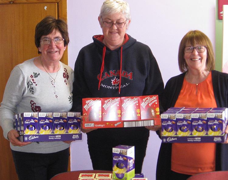 Rotarians Margaret and Chris holding the 50 eggs provided last time for the children at Stafford Women's Aid. 