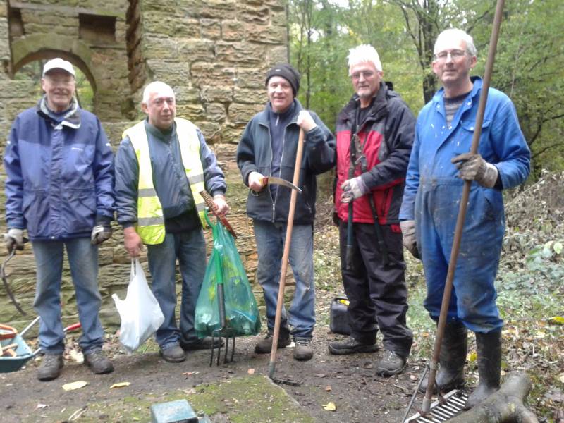 President Geoff Goodlad (second from right), plus three volunteers from Rockley Rotary, at work clearing debris and leaves outside the historic furnace and engine house