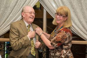 Cliff Blanchet receives his new Rotary badge from President Toni.