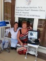 Dr Grace Spencer and Debra Alpha outside the St Maarten clinic, with showing the footcare equipment