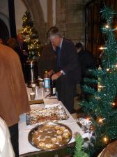 President gordon serving mulled wine after the service.