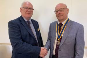 Cambell Keay is greeted by Oswestry Rotary Club President Ian Glenister