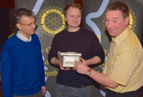 Adam Varley (centre) shows President-Elect George Morrison (right) and Russell Wheater, Speaker"™s Host, a geiger counter from the time of the Chernobyl disaster