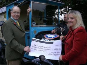 Mick Kemp presents a cheque to the sum of £25,000 to the lady McAdden's Appeal