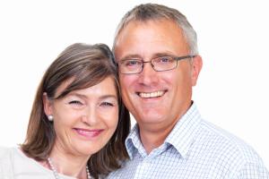 A smiling middle-aged couple