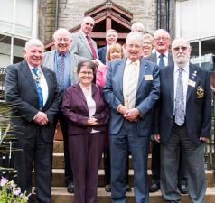 From left, President Bill Knox, New member Branwen Rees, Past President Mike Kimpton and DG Andy Lees with District International Convenor Iain Barr and some members of Greenock Rotary