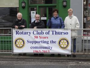 Club members with the Thurso banner in the town.