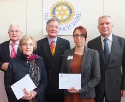President-elect of the Rotary Club of Oadby, Lindsay Hubbard, and collection organiser John Fowlds (left) with the recipients of the cheques, Vicki Heath, Jen Leach and Michael Griffiths (right)