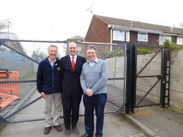 Phil Taylor, CEO of ArclorMittal Kent Wire Ltd standing in front of the finished gates with Rotarian Bill Parkinson and Paul Clark from the Community Centre.