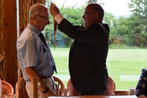 Past President John Reid hands over the chain of office to President Harry Millar