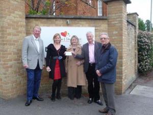Rotarians present a cheque for Â£500 and enjoy a tour of Helen & Douglas House