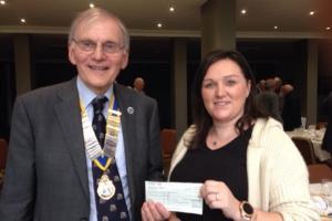 President Chris presents a cheque to Faye