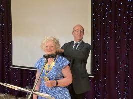 President Margaret receives the chain of office from outgoing president Bob