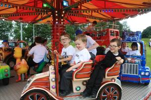 Kings Park school children enjoy a fairground ride at Rotary Kids Out