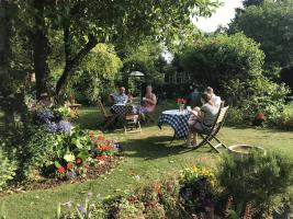 Visitors enjoying refreshments in one of the gardens