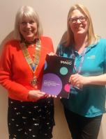 President Renate presented with Imago Brochure by Fiona Cottingham