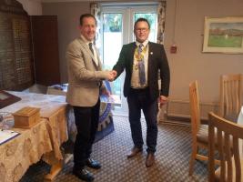 President Keith Davies congratulates Ken Jones on becoming a member of the Rotary Club of Abergavenny