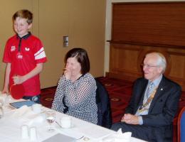 Joshua during his talk, with mother Yvonne and President Brian