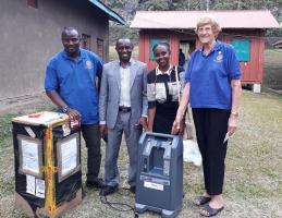 The photo shows the two essential Oxygen concentrators being unpacked at Kagando Hospital alongside two local Rotarians are Canon Dr Benson Baguma the hospital Director and with the stethoscope is Dr Kemigisha the emergency doctor.