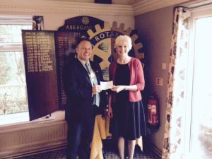 President Keith Davies presents a cheque to Sally Morris of St Thomas Hospice