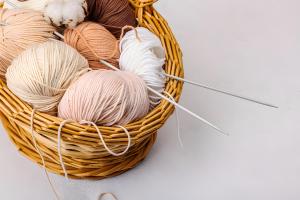 Knitting needles and wool in a basket