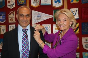 The photograph shows Nitesh being presented with his badge by Wendy.