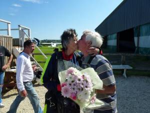 Club President welcomes Anne back to earth with a bouquet of flowers
