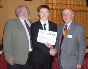 President Nominee, Gwyn presents the RYLA Certificate to Connor Shakespeare in the presence of Alwyn, Youth Services chair
