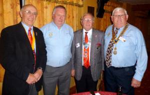 District Governor flanked by President Brian (right) and President Elect Gwyn and Secretary Gwynn on the left.