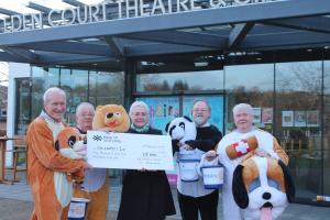Left to right: costumed Rotarians David Henderson, Iain Macintosh, Neil Anderson and Donald Robertson present the cheque to Jane Clunas from Children 1st.
