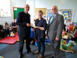 Rotarians Vernon Heritage and Charles Harper present the cheque to Mrs Freddy Edmunds