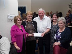 Members of Port Glasgow URC Foodbank receive a donation from President Bill Knox