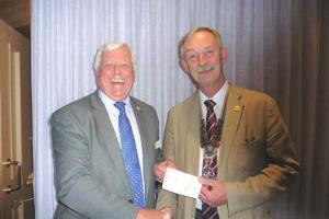 Senlac President, Roger Young, handing a cheque to Reg Dove of Chestnut Tree.