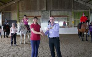 President Carl Watson presents Julie Mace, Secretary of Rawreth RDA, with a cheque for £250