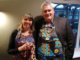Club president Kevin Basden and Mary Watkins model some of the creations of the Isoko Women’s Cooperative.