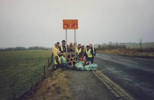 The Club at the clean-up road sign