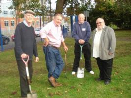 Pupils and Crewe Rotarians having completed planting 1000 purple crocus at Sir William Stanier High School