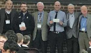 Representatives of the Lions Club and Rotary present cheques to the school