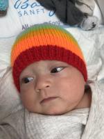 Ukrainian Baby wearing his Rotary knitted hat for warmth