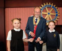 President Alan presenting the check to St Mary's RC Primary School pupils Kira Fjodorova and Edward Millar.