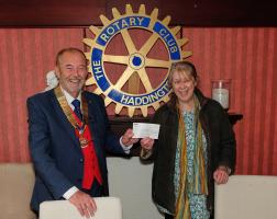 President Alan presenting the cheque to Laura Samuels, Chair of Blooming Haddington