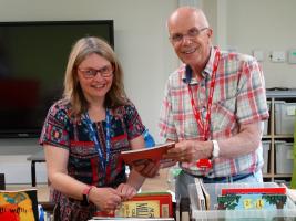 Local Rotarian Roderick Hunt presenting books at a local primary school
