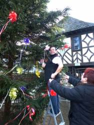 Past President Philippa and her husband Colin tying the bows on the tree