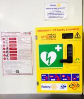 Milton Keynes Station Defibrillator,with instructions and a dedication plaque.